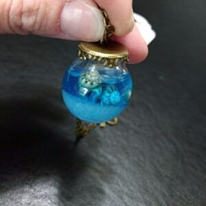Gold tone ocean in a bottle necklace blue Bow